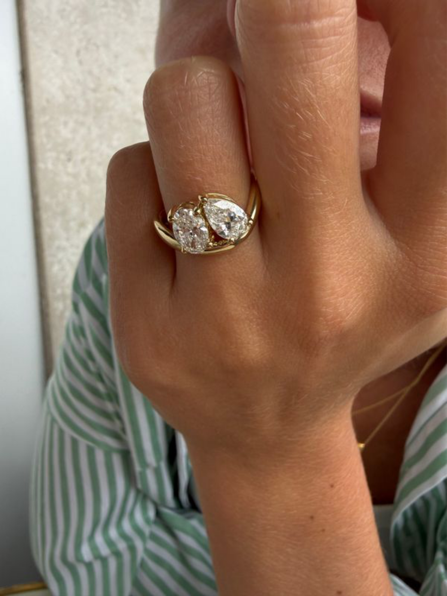 GIGI two stone engagement ring worn on hand in solid yellow gold, available with natural diamonds by DÉSIR