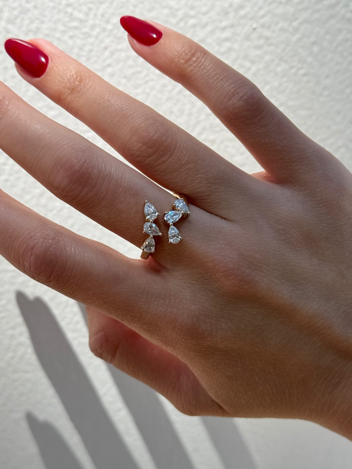 Close-up of pear-cut diamonds wrapping around the ONVI 9ct yellow gold ring, available as a custom jewellery piece