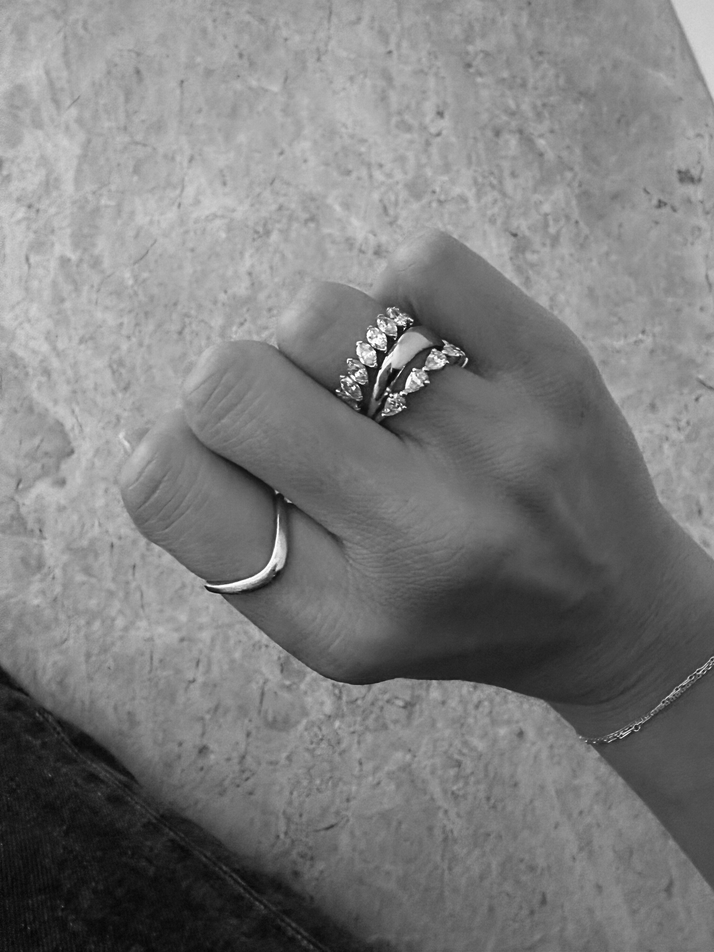 Close-up of the polished curved stacking band on the SIA 18ct white gold ring, available as a custom design