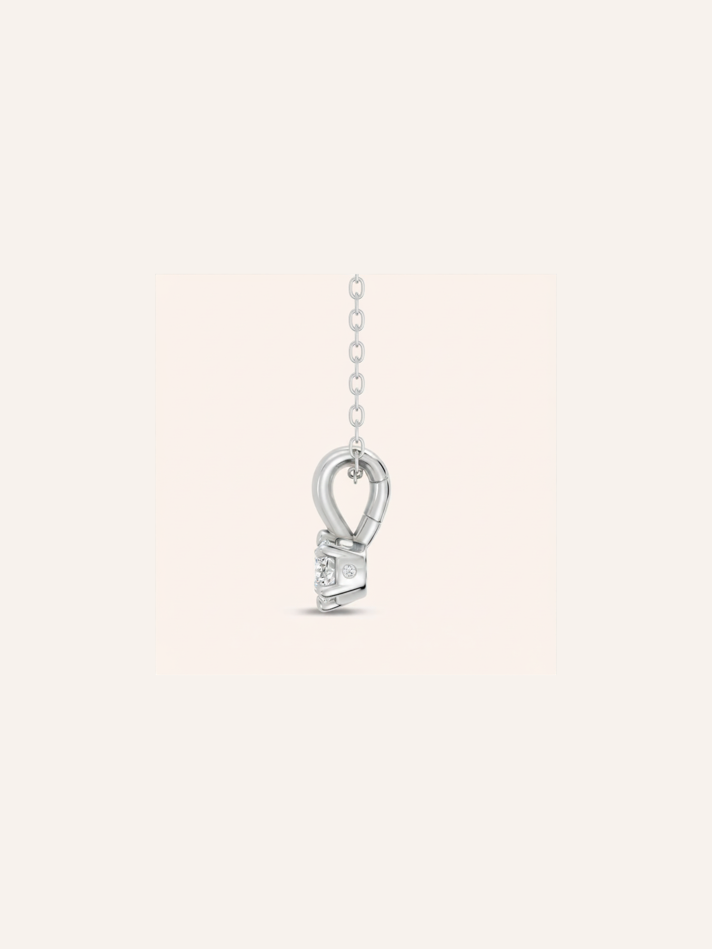 Side view of the ARLO pendant showing the east-west oval diamond in a six-claw setting of 18ct white gold with a single accent stone