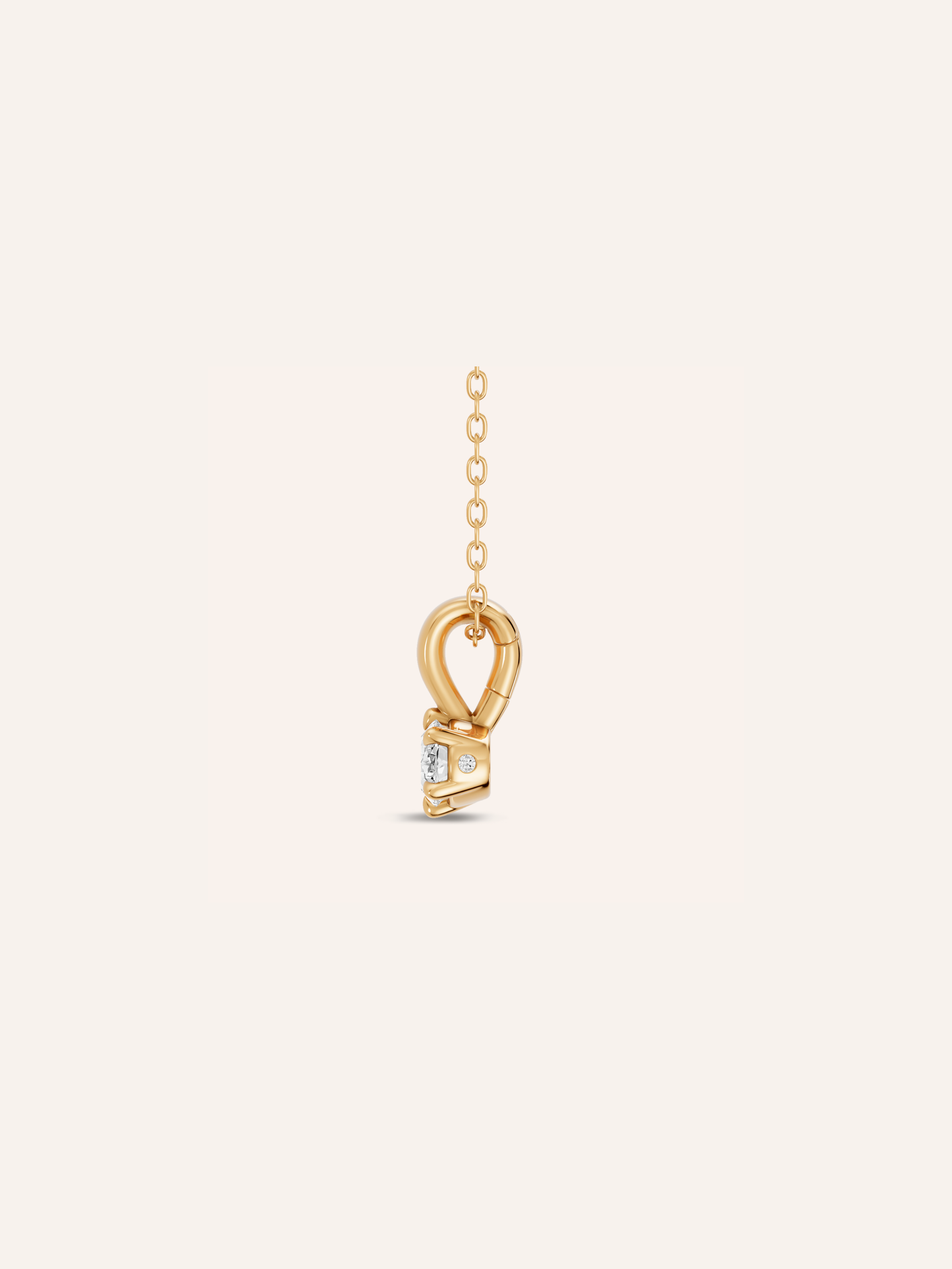 Side view of the ARLO pendant showing the east-west oval diamond in a six-claw setting of 9ct yellow gold with a single accent stone