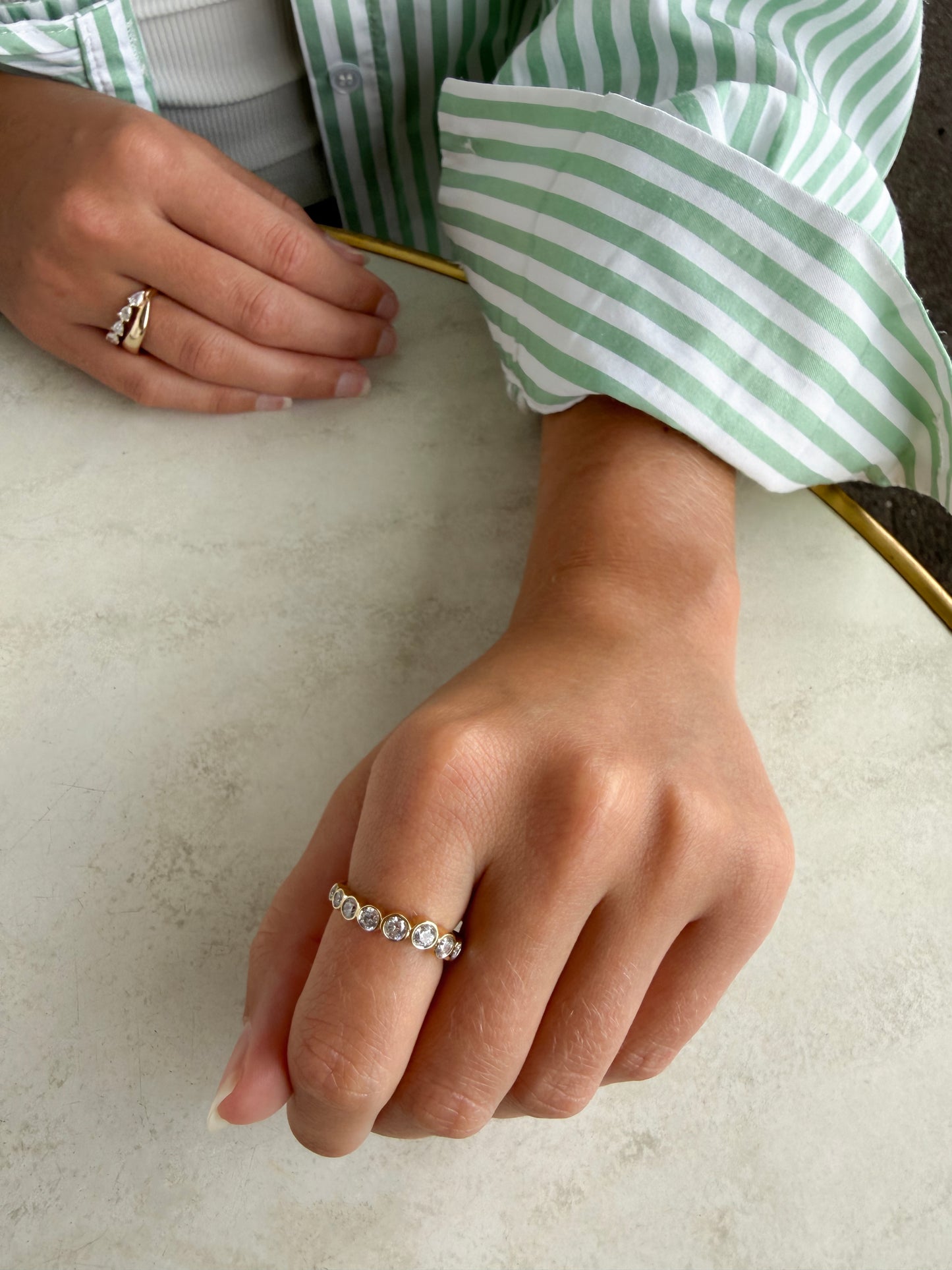 Close-up of the graduating bezel-set diamonds on the AVA 9ct yellow gold ring, available as a custom piece