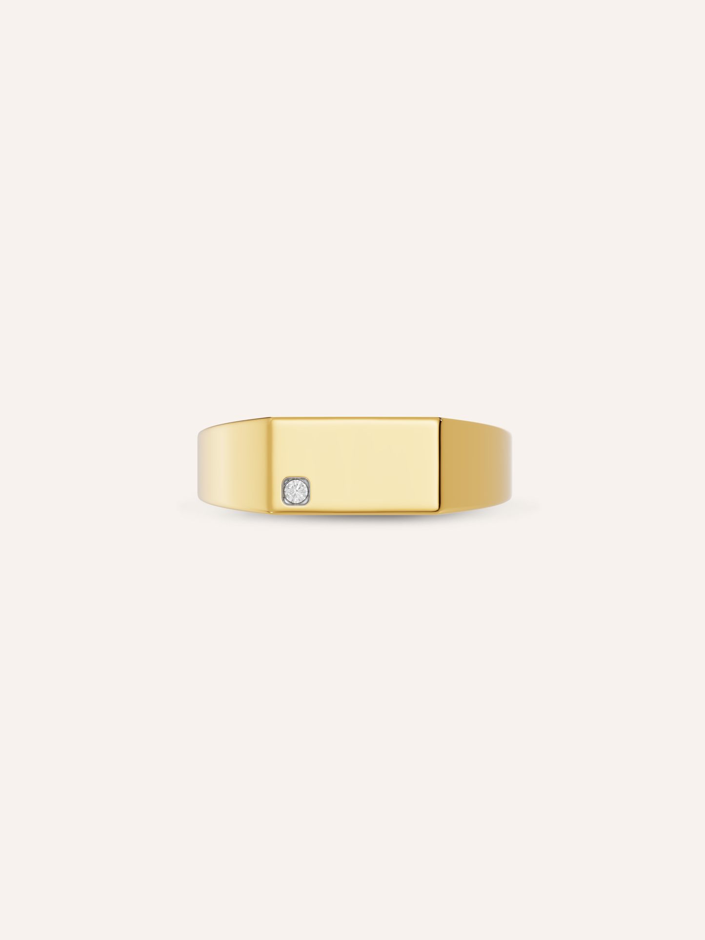 Detail of the AXEL signet showing a round lab-grown diamond set into the rectangular face in solid yellow gold, also worn as a men's pinky ring, a custom signet by DÉSIR
