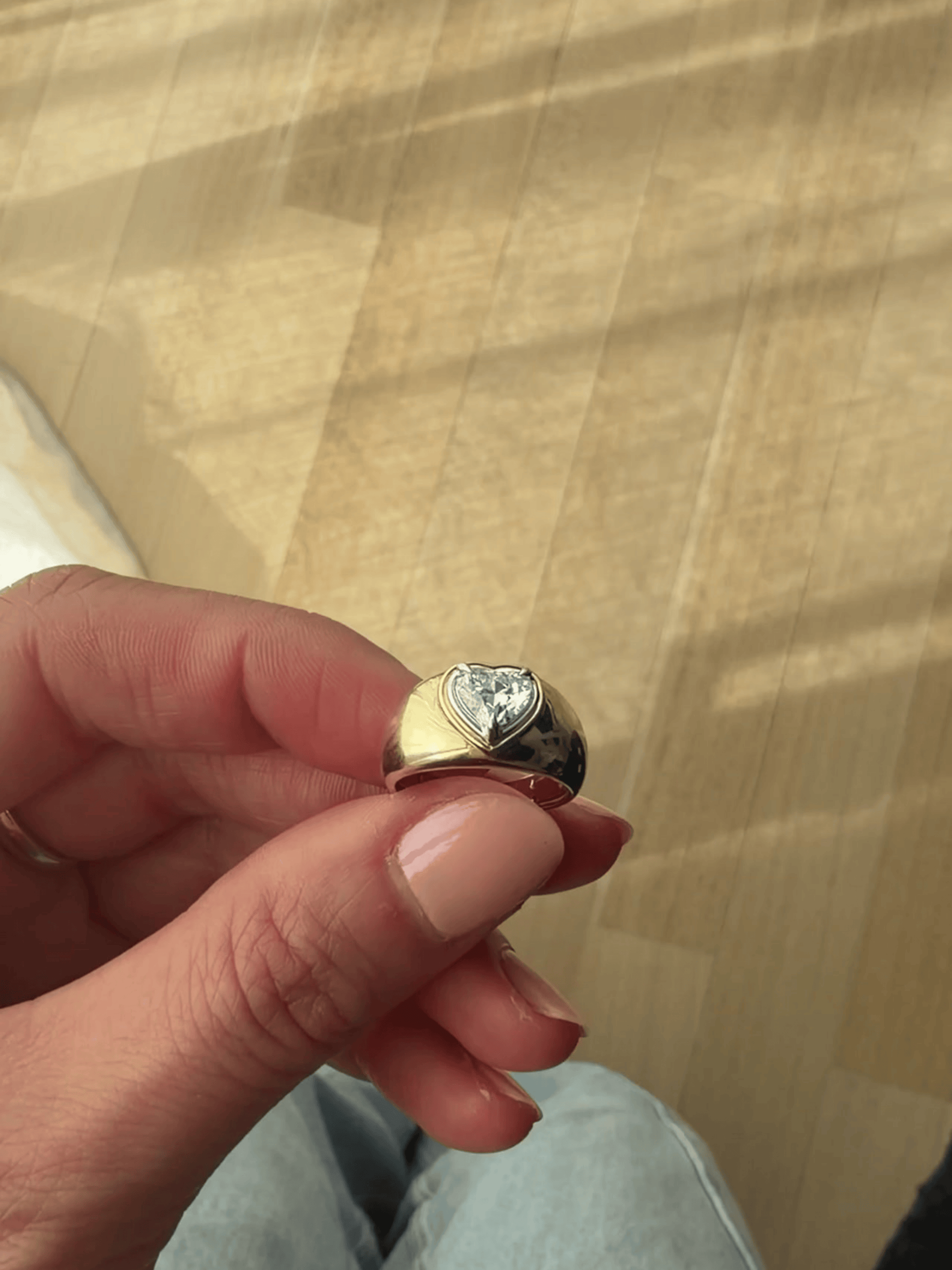 Close-up of the heart detailing inside the band of the DINA 9ct gold bezel signet ring, available as a custom piece