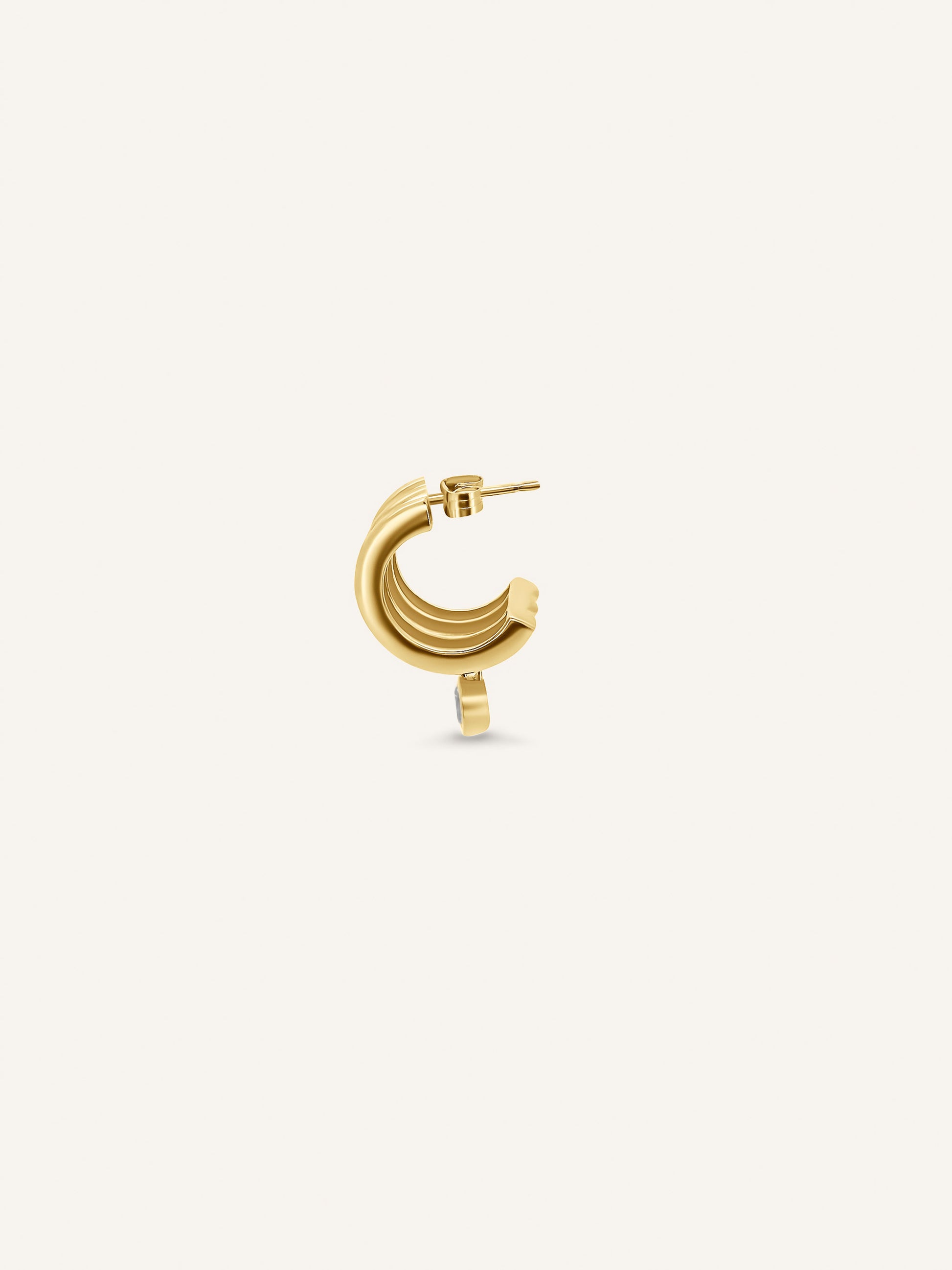 Side view of the FRANKI hoop showing three sculptural gold bands with a single round diamond suspended beneath