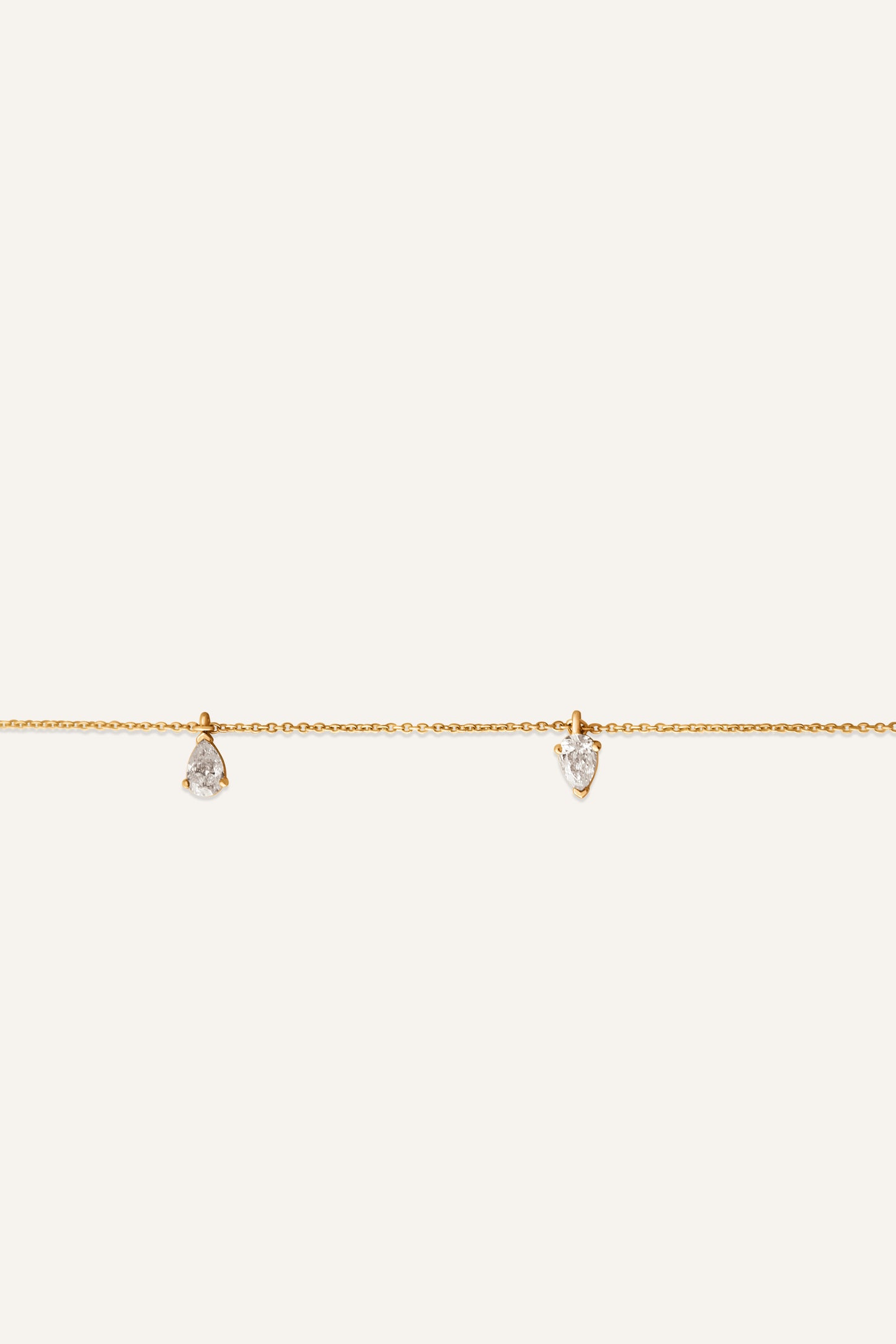 REYA pear diamond necklace worn on neckline in 14ct yellow gold by DÉSIR, made for the diamond necklace stack