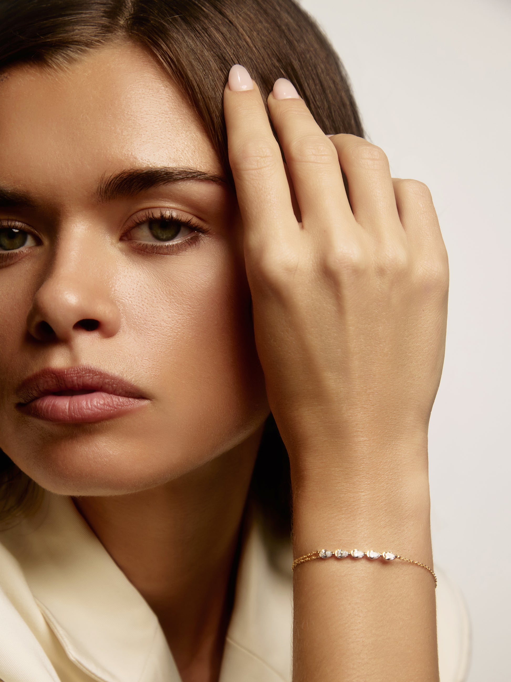 Close-up of five east-west pear lab-grown diamonds on the GIA yellow gold bracelet, available as a custom piece