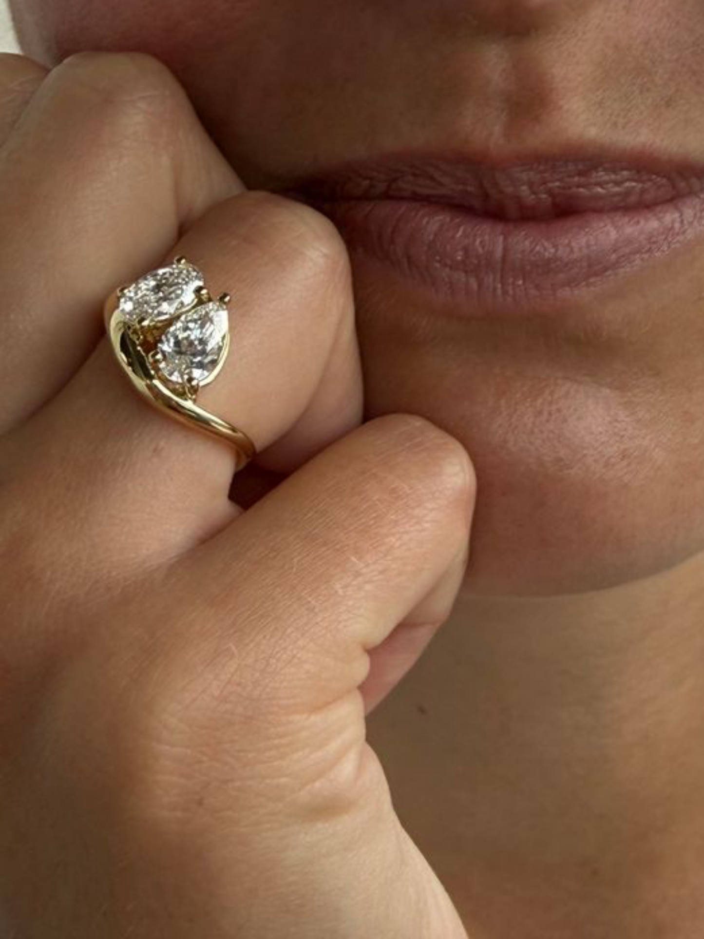 Close-up of the oval and pear-cut lab-grown diamonds prong-set on the GIGI toi et moi ring