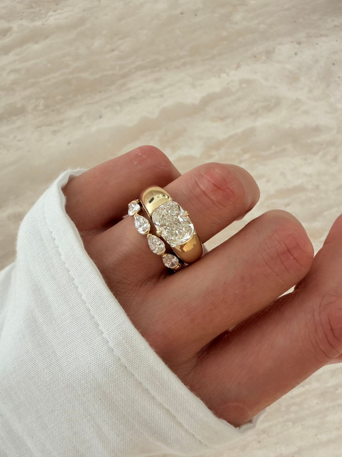 Close-up of the recessed engraving panel and hammer-set diamonds on the KAIA solid gold band, available as a custom engagement ring