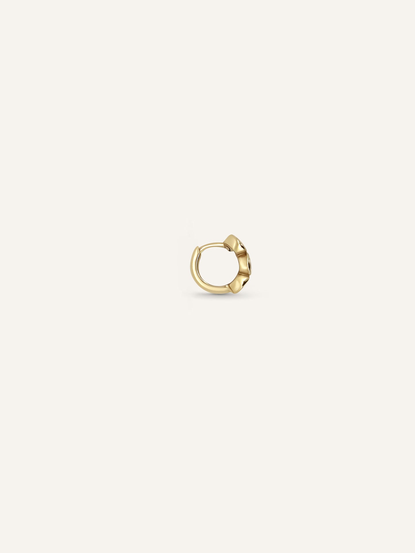 Side view of the LEA huggie showing three lab-grown diamonds bezel-set across a 10mm yellow gold hoop