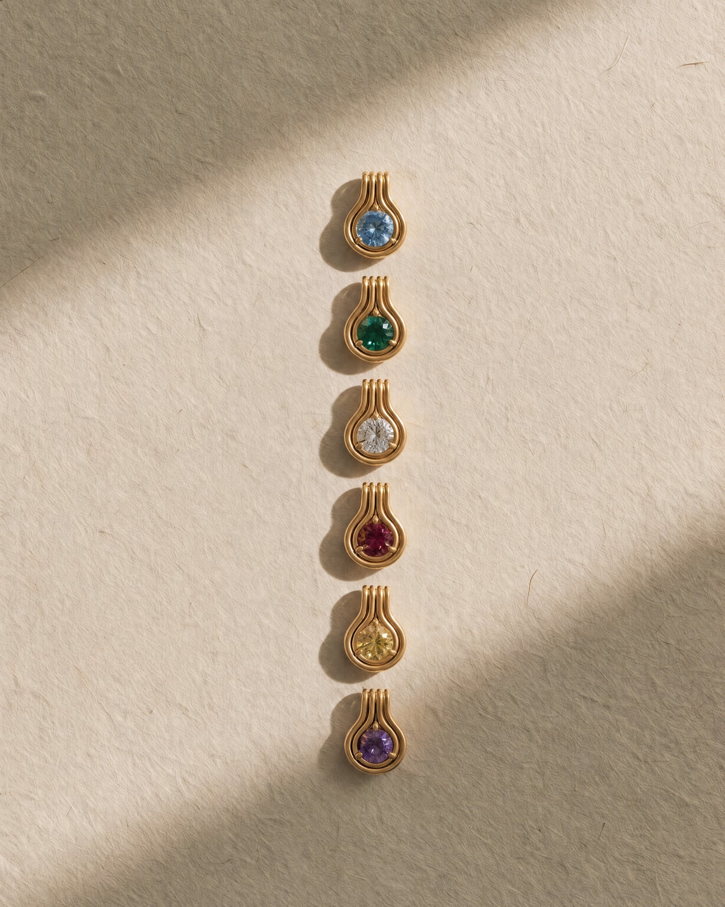 NOA birthstone pendant worn on the neckline in 9ct yellow gold, a personalised gift with a hinged bail that clips onto a thicker chain
