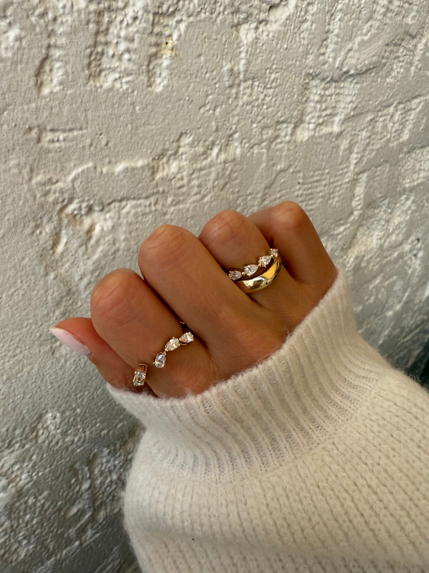 Side view of the RUBI wrap showing five pear-cut diamonds set east-west in open basket settings in solid 18ct yellow gold