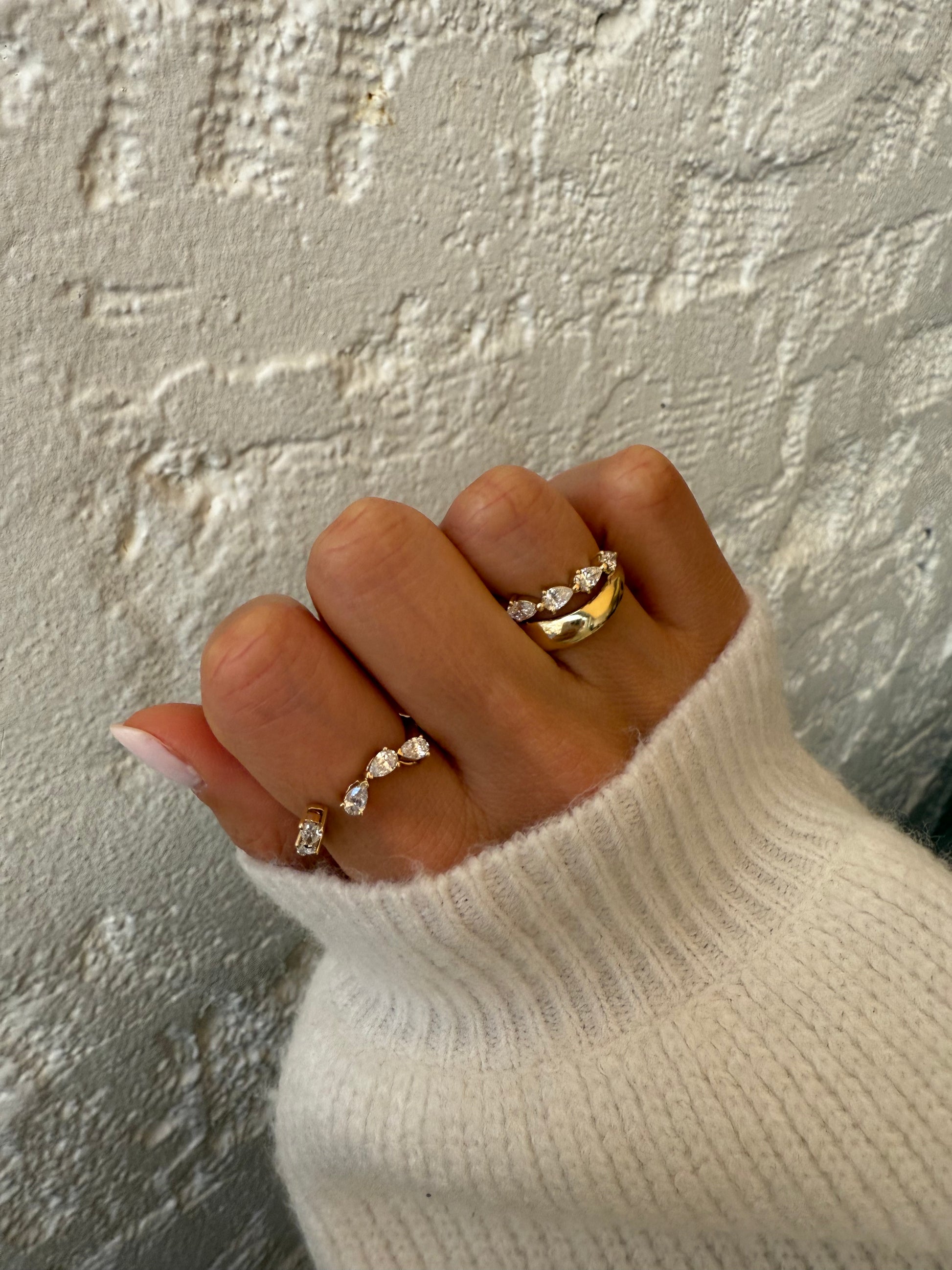 Side view of the RUBI wrap showing five pear-cut diamonds set east-west in open basket settings in solid 18ct yellow gold