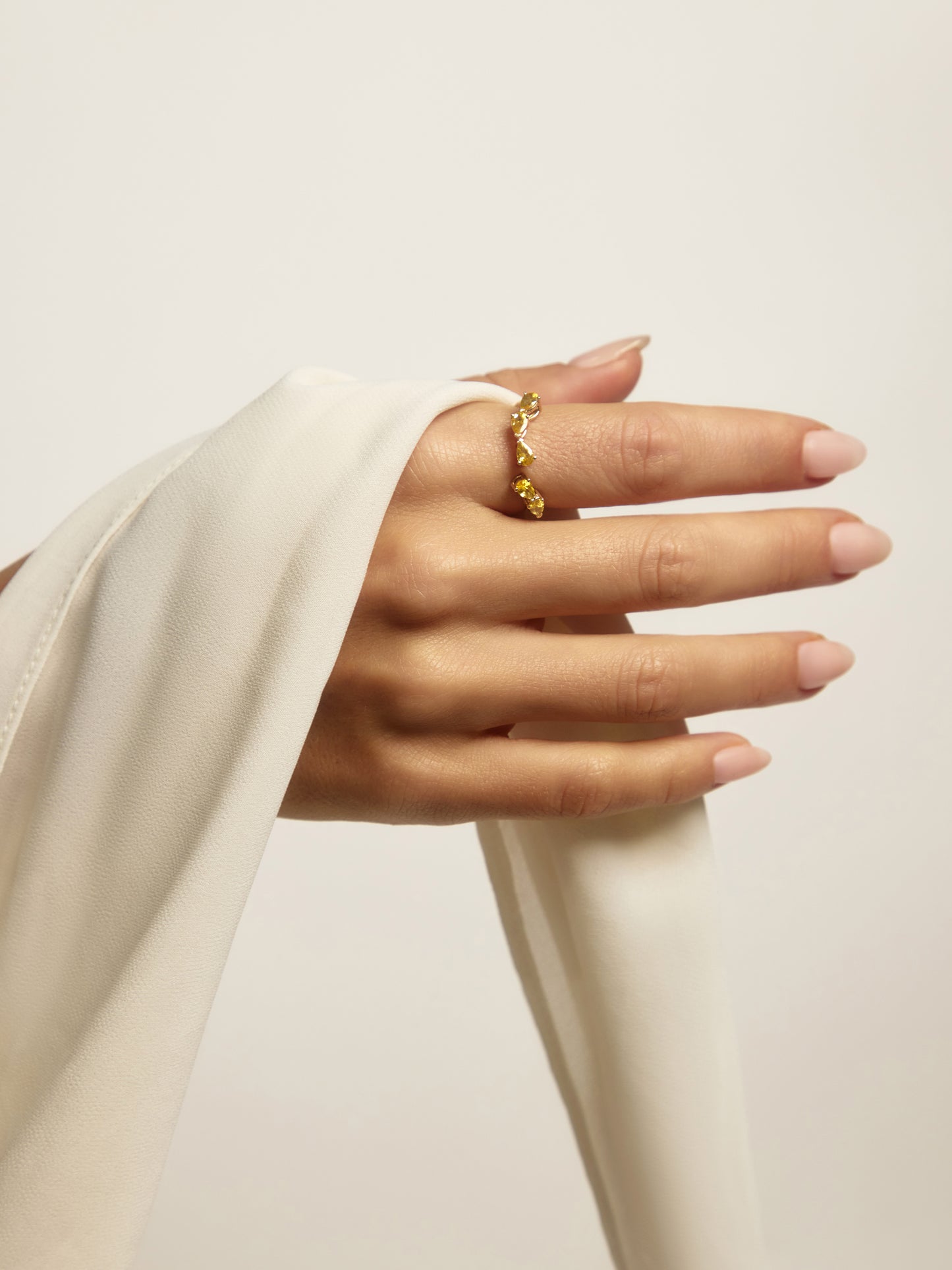 Close-up of five pear-cut yellow sapphires set east-west on the RUBI wrap, an Australian-made coloured stone ring