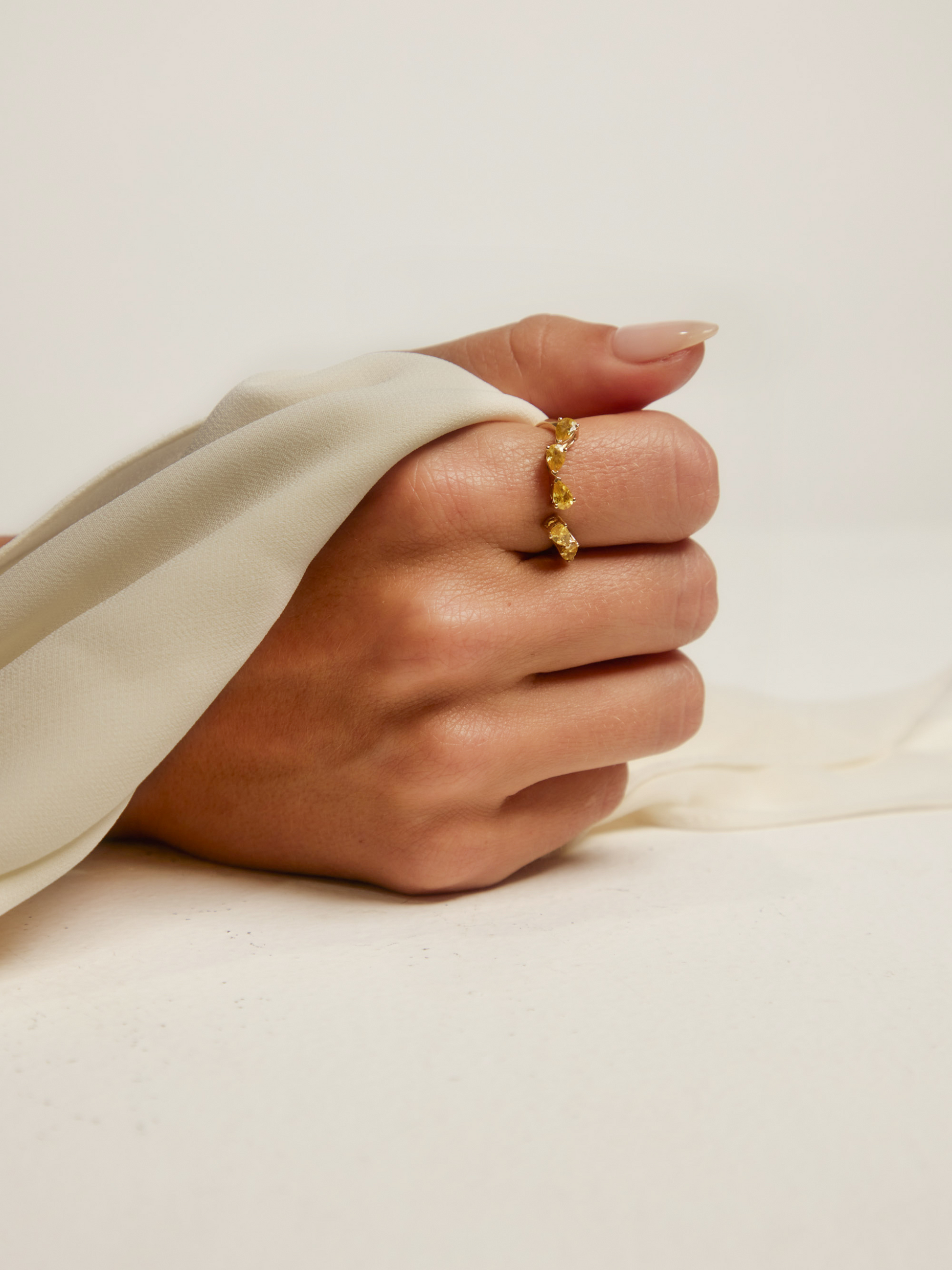 Side view of the RUBI yellow sapphire wrap showing five pear-cut sapphires set east-west in solid 18ct yellow gold
