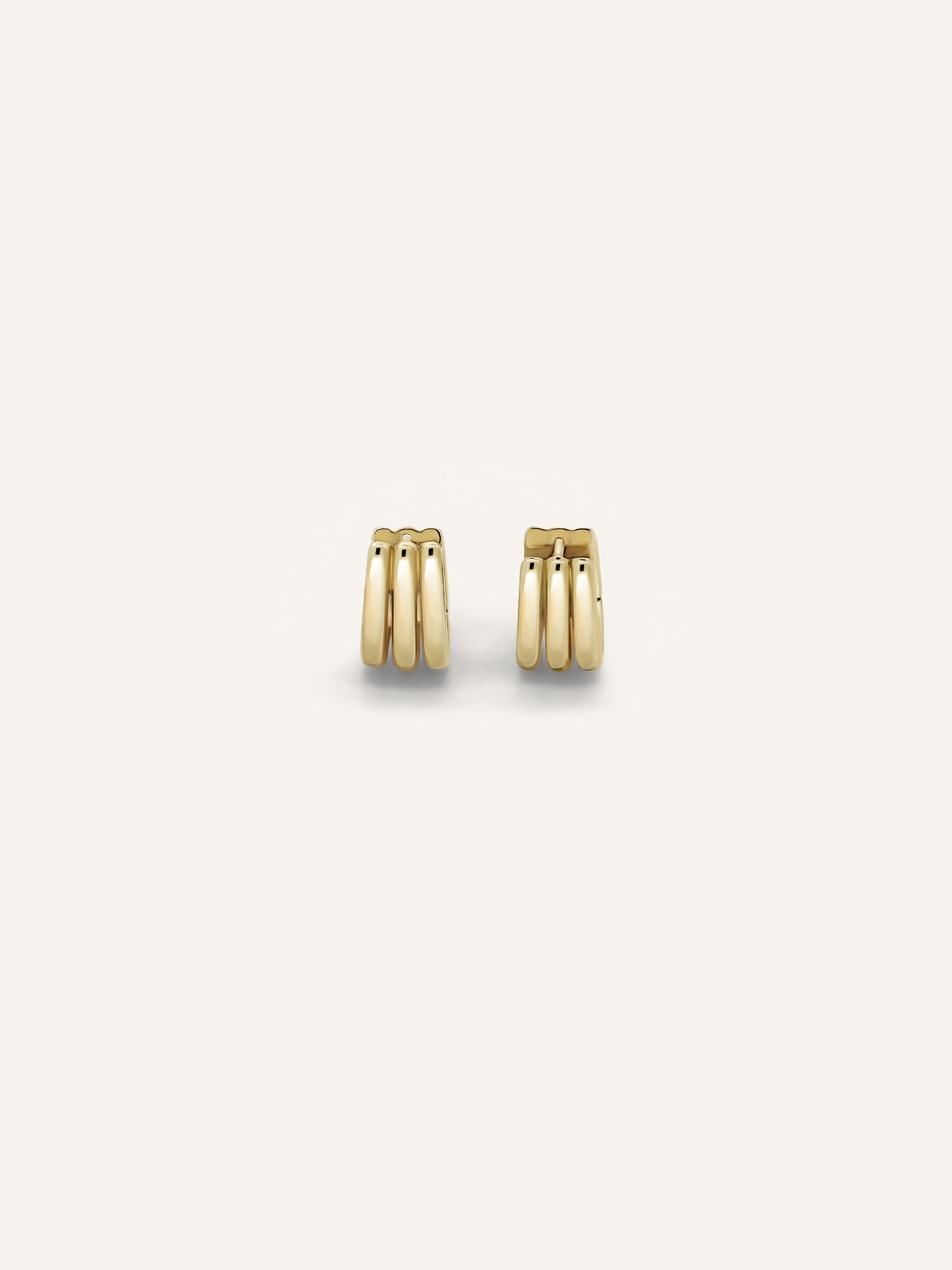 The SENA huggies, a sculptural gold huggie earring in solid 18k yellow gold by DÉSIR, a luxury Australian jewellery brand