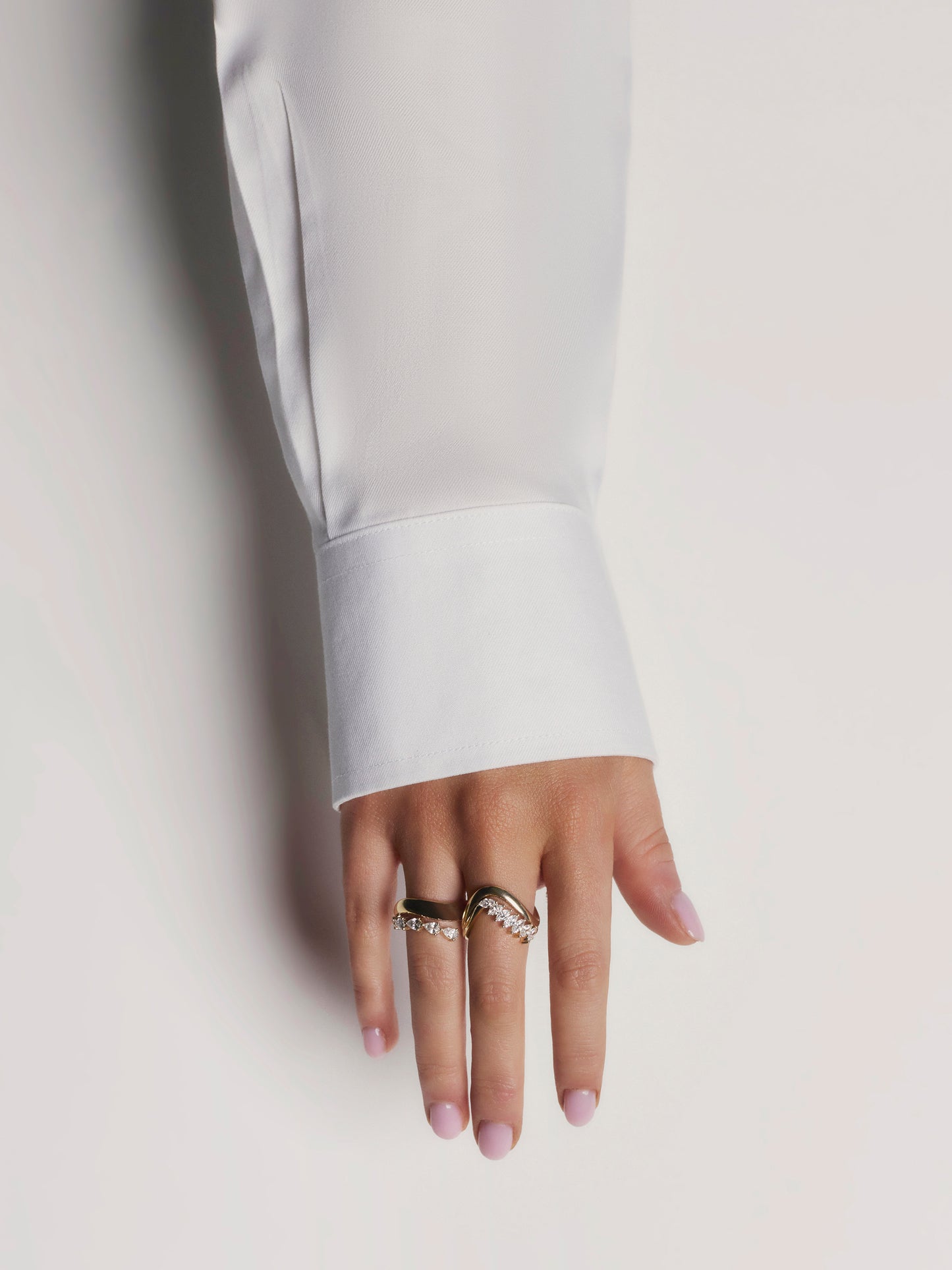 Side view of the SIA ring showing eight marquise lab-grown diamonds cascading down a sculpted yellow gold curve
