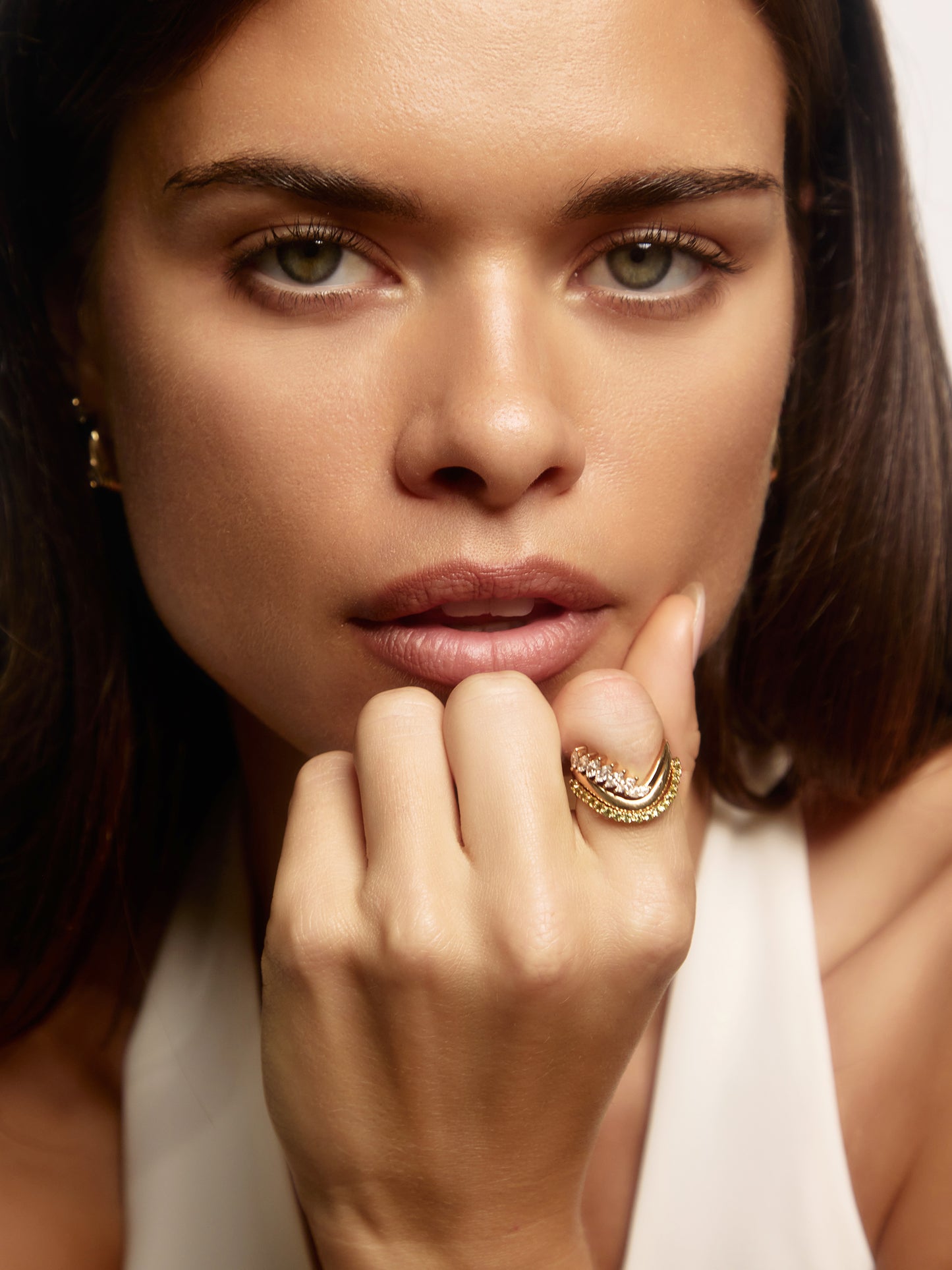 Close-up of the pavé peridot on the SIA 9ct yellow gold ring, the August birthstone, available as a custom piece
