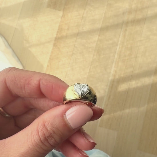 Close up of the DINA heart signet ring showing the heart-shaped diamond and mixed yellow and white gold double bezel setting