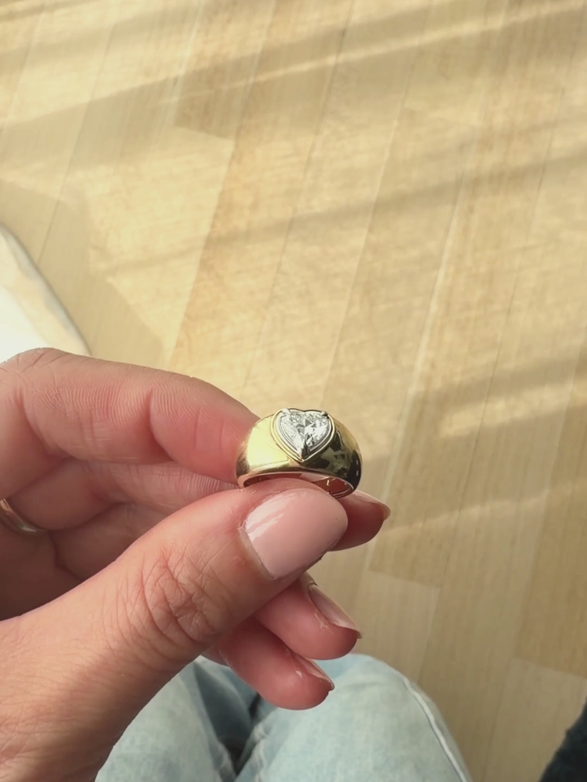 Close up of the DINA heart signet ring showing the heart-shaped diamond and mixed yellow and white gold double bezel setting