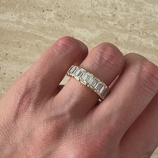 Side view of the ZARA eternity ring showing nine emerald-cut diamonds across a band of solid 18ct yellow gold